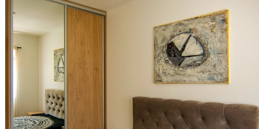 Bedroom with tufted headboard and artwork, Plumeria Loft Budva